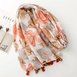 Detail of a floral cotton linen scarf featuring dual-tone tassels and elegant flower prints