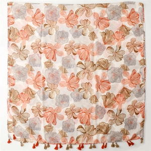 Detailed view of large floral print scarf with soft tassels and translucent fabric texture