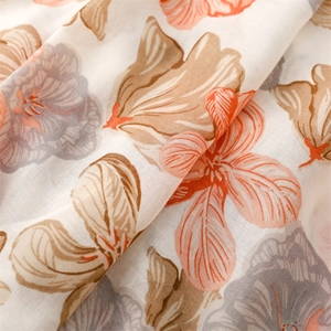 Detailed close-up of floral print linen-feel scarf with orange and blue blossom patterns