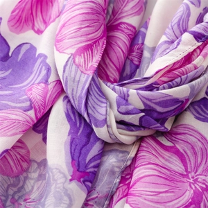 Macro detail of cotton-linen scarf with floral print pattern and woven fabric texture