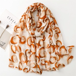 Linen-feel shawl with golden foil donut print and raw edges for women in beige