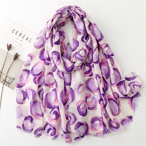 Detail of pink cotton-linen scarf with gold foil donut patterns and soft frayed edges