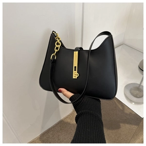 Detail of a black matte PU leather half-moon bag featuring a gold chunky chain strap