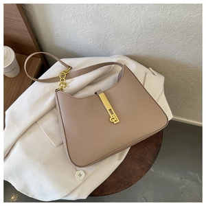 Close-up of beige PU leather hobo bag with a luxury gold metal buckle and chain strap