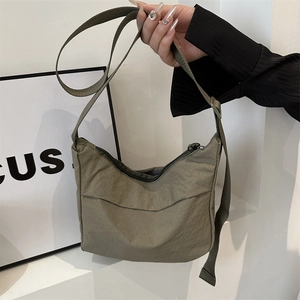 Army green nylon crossbody crescent bag with adjustable strap and zipper closure