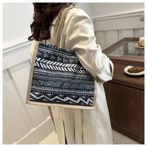 Close-up of geometric pattern linen tote bag with brown rustic hemp borders and handles