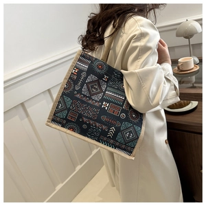 Close-up of bohemian linen tote bag featuring tribal patterns and geometric motifs