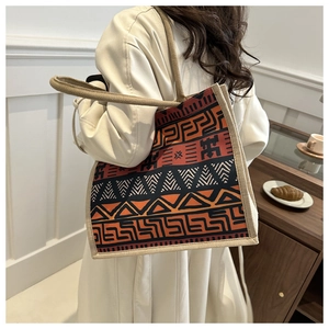 Close-up of geometric pattern jacquard fabric and reinforced handle on the tote bag