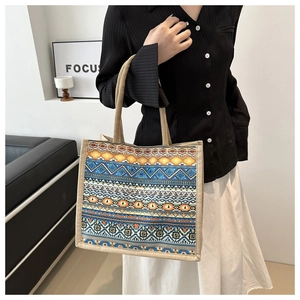 Detail view of Bohemian woven tote bag with colorful geometric patterns and handles