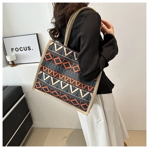 Close-up of bohemian woven tote bag showing geometric patterns and ethnic texture