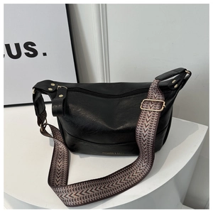 Chic black PU leather crossbody bag with geometric woven strap on a white stand