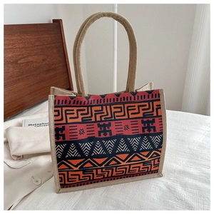 Detail of bohemian burlap tote bag with tribal geometric patterns and rope handles