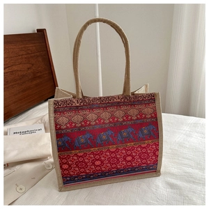 Close-up of bohemian linen tote bag showing ethnic elephant print and jute fabric texture