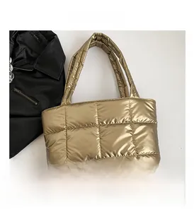 Top view of metallic gold quilted tote bag with soft padded texture and shoulder straps