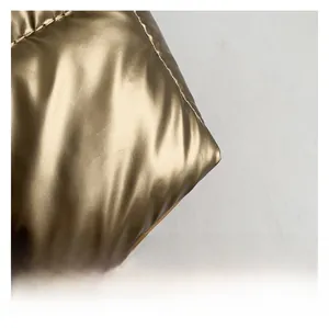 Macro shot of metallic gold quilted fabric showing high-quality waterproof texture