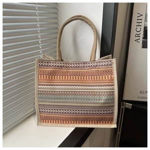 Close-up of ethnic tote bag showing striped jute texture and woven rope handles