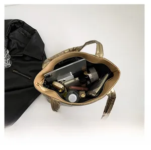 Interior view of gold quilted tote bag showing large capacity for essentials