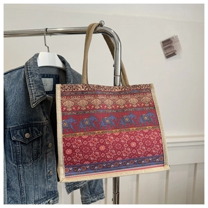 Detail of bohemian burlap tote bag featuring ethnic elephant print and floral patterns