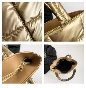 Macro details of golden quilted puffy tote bag featuring metallic fabric and metal zipper