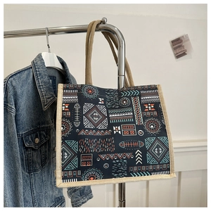 Detail of bohemian tote bag featuring ethnic geometric patterns and durable woven handles