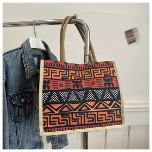Detail of bohemian tote bag with geometric patterns and sturdy cream rope handles