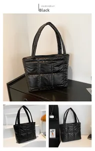 Détail du sac fourre-tout matelassé noir avec texture rembourrée et anses solides