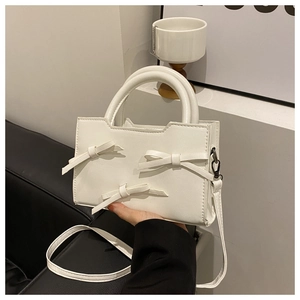 White minimalist PU leather handbag with elegant bow details and versatile crossbody strap