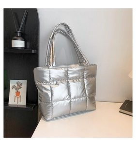 Détail du sac cabas matelassé argenté avec texture quadrillée et larges bandoulières