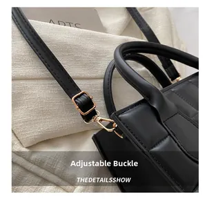 Detail shot of the adjustable gold buckle and strap on the black quilted handbag