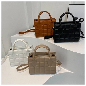 Quilted crossbody bags set in brown black white and beige on display stands