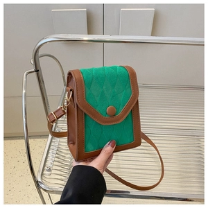 Détail du sac bandoulière patchwork vert et marron avec texture matelassée et boucles