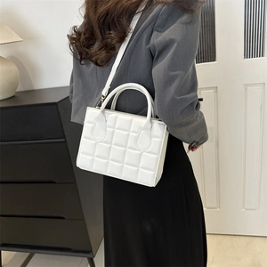Chic white quilted handbag for women with versatile shoulder strap and top handle