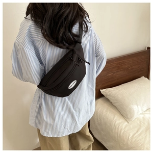 Stylish black nylon dumpling crossbody bag with dual braided zippers and white logo patch