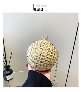 Detail of gold spherical evening clutch featuring crystal mesh and circular ring handle