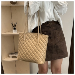 Quilted tote bag detail showing large capacity, chic beige faux leather and shoulder straps