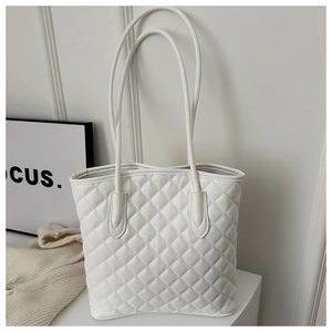 Detail of white quilted tote bag featuring elegant diamond stitching and soft faux leather texture