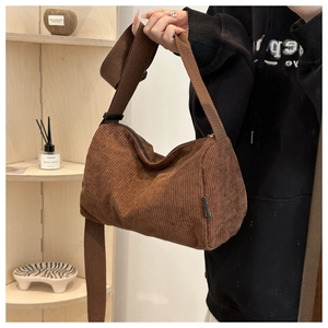 Close-up of brown corduroy tote bag featuring vertical stripes and a soft texture