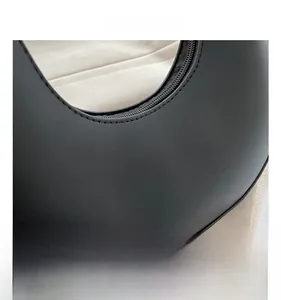 Detail of smooth black leather texture and fine stitching on a French style handbag