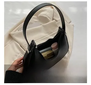 Interior view showing spacious capacity of black leather crescent shoulder bag