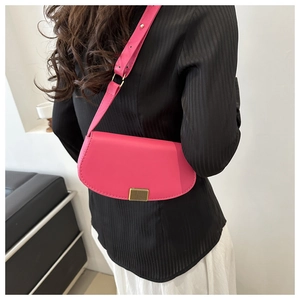 Detailed side view of a magenta PU leather shoulder bag with gold metal buckle