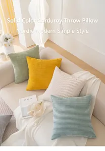 Detail showing the thick textured corduroy fabric and diverse colors of square cushion covers