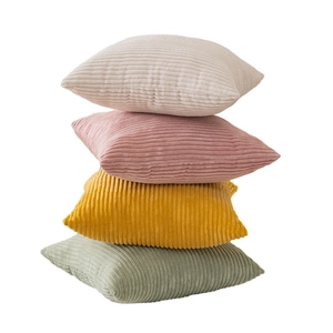 Minimalist corduroy pillow covers stacked in cream, rose, yellow, and sage green colors