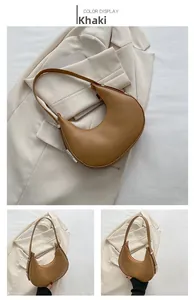 Detail view of khaki crescent shoulder bag with matte leather texture and zipper closure