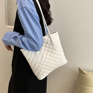 Classic white quilted tote bag with diamond pattern and long shoulder straps for women