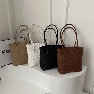 Quilted oversized tote bags in assorted colors featuring rhombus stitching and long handles
