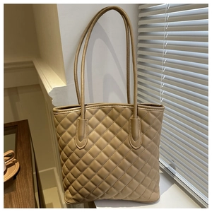 Close-up of quilted pattern detail on the warm khaki faux leather tote bag