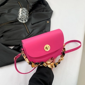 Fashionable magenta saddle crossbody bag with golden lock and silk scarf chain handle