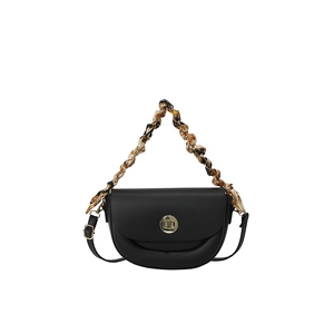 Chic black saddle bag with a silk scarf handle and golden twist-lock closure
