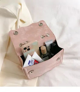 Detail view of pink crossbody bag interior showing spacious capacity for phone and cosmetics