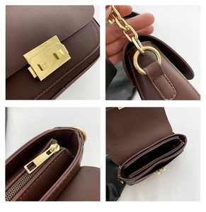 Detail of dark brown leather bag with golden square lock and metal chain strap details